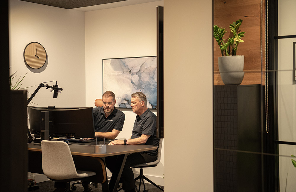 Symsafe expert IT consultants in discussion with a client
