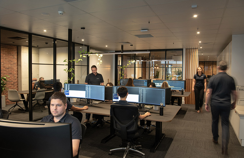 Symsafe cybersecurity specialists reviewing a client environment