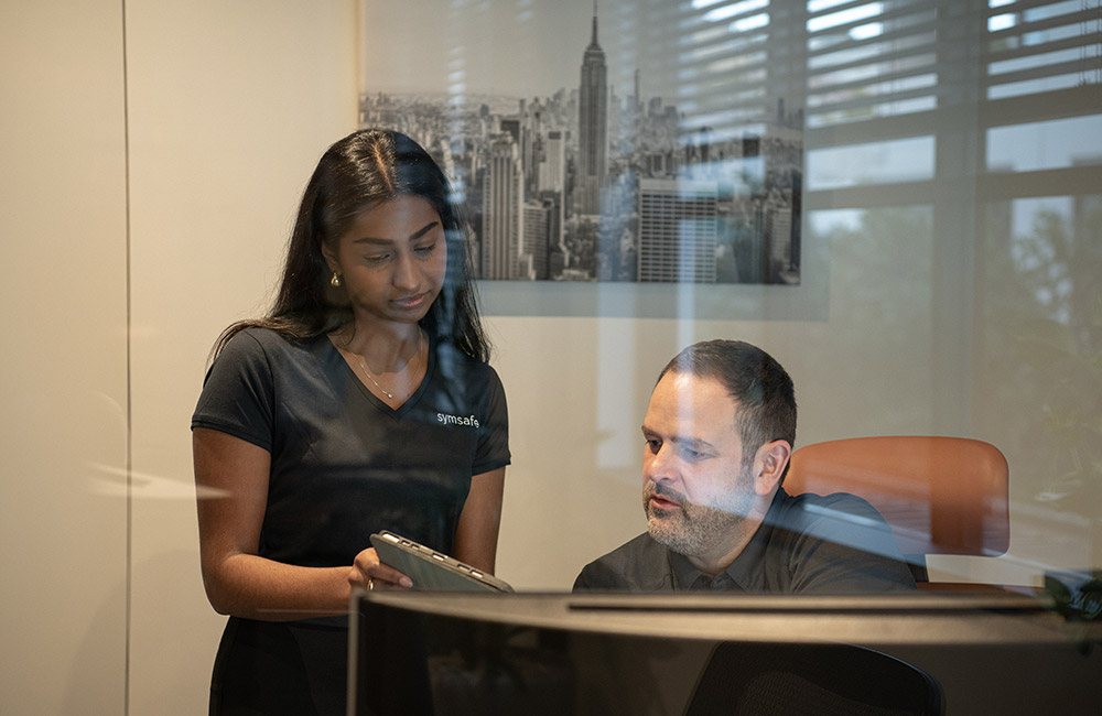 Members of the Symsafe executive team checking results after running a Symtest Penetration Test
